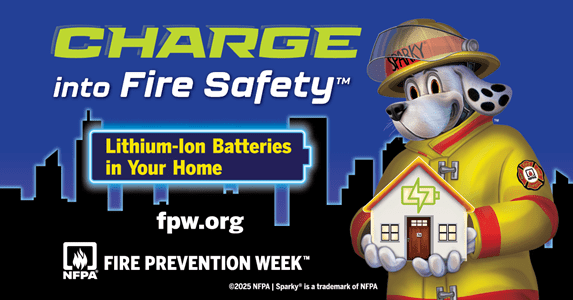 Sparky the Fire Dog promoting fire safety with lithium-ion batteries, holding a house model for this year's Fire Prevention Week.