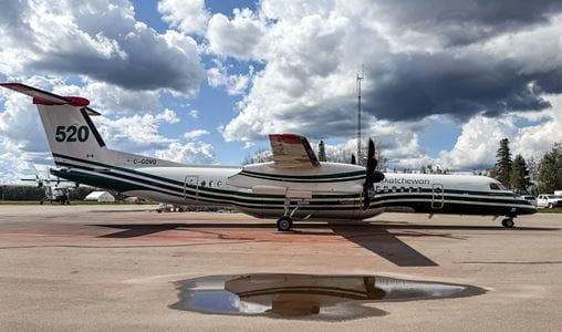 Q400 aircraft sitting on the tarmac with a cloudy sky